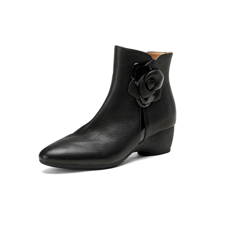 Black ankle boot with a flower detail on a white background，side view