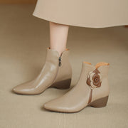 Beige ankle boots with a floral design on a beige background