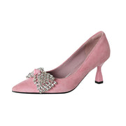 Pink high-heeled shoe with a decorative bow on a white background,suede upper kitten heel pumps.