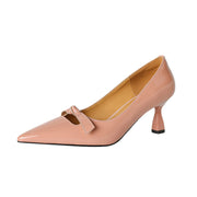 A pink pointed toe kitten heel pump with a bow detail.