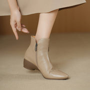 Beige ankle boot worn by a person on a beige background